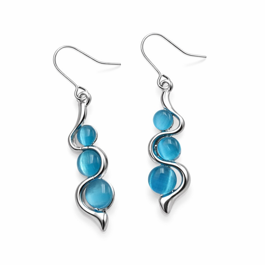 Blue wave dangle earrings with silver swirl design and turquoise blue beads on white background