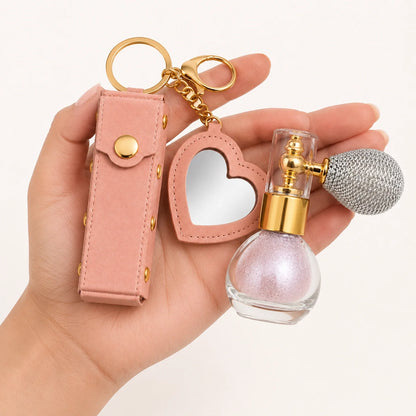 Birthday Glow Gift Set detail view showing blush pink holder texture, heart mirror, gold hardware, and pink shimmer atomizer