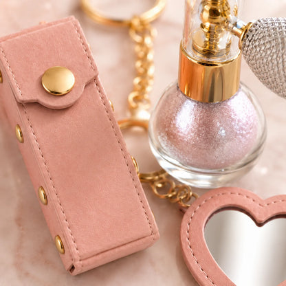 Birthday Glow Gift Set lifestyle image showing subtle pink body shimmer with heart mirror lipstick holder keychain
