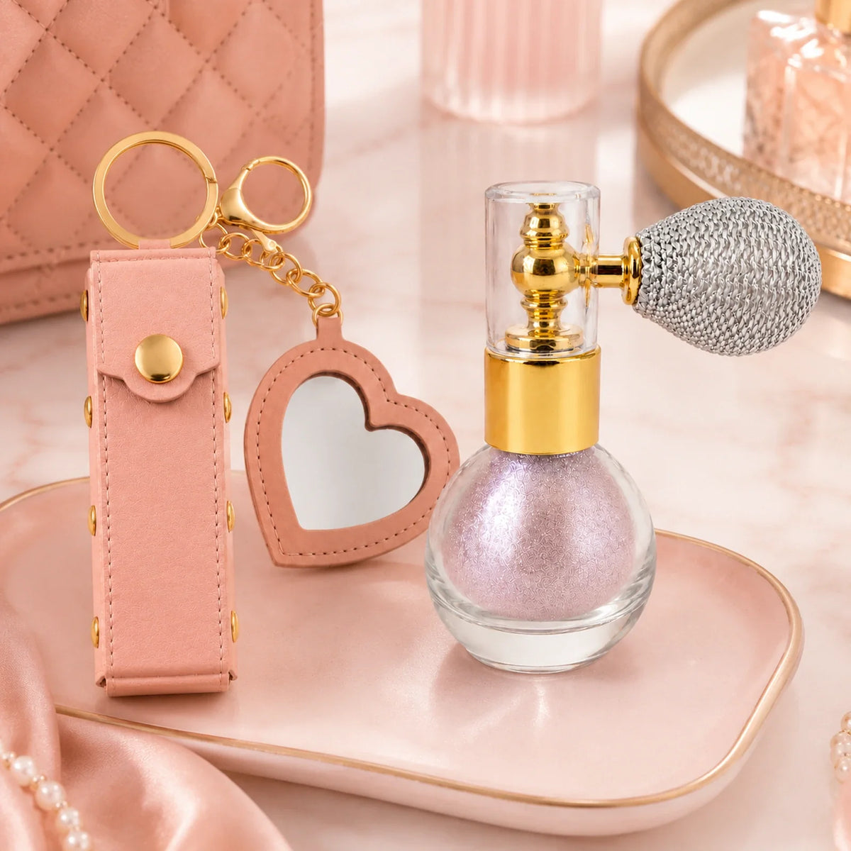 Birthday Glow Gift Set scale view with heart mirror lipstick holder keychain and soft pink shimmer atomizer held in hand