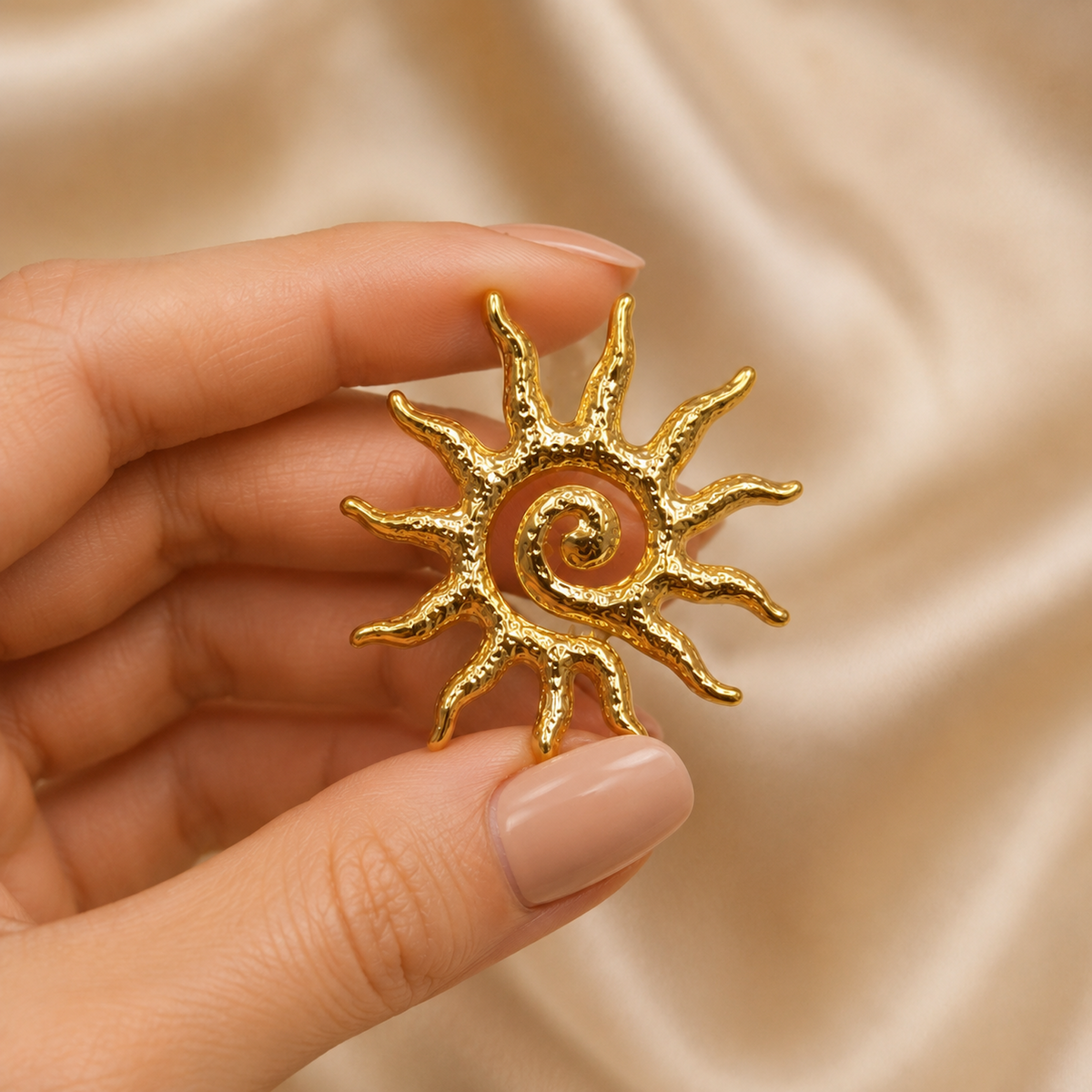 Gold Sun Statement Earrings styled on champagne satin