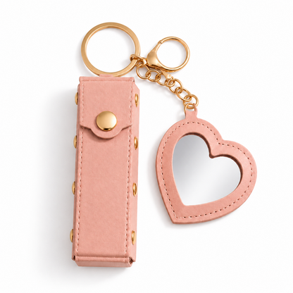 Pink Lipstick Holder and Mini Heart Mirror Keychain with gold hardware on a clean light background