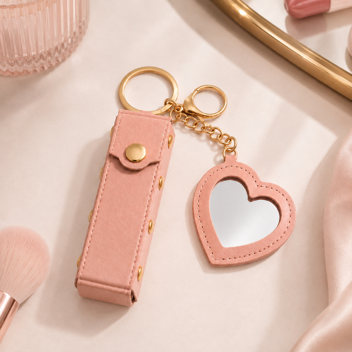 Pink Lipstick Holder and Mini Heart Mirror Keychain styled on a soft feminine vanity