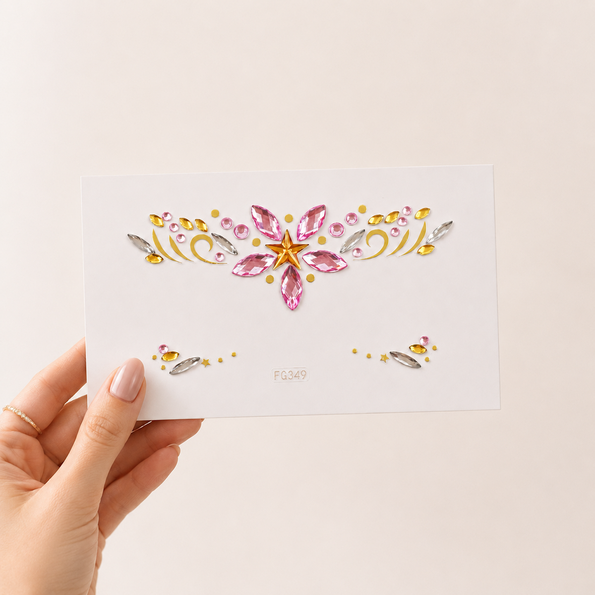 Pink Star Festival Face Gems card held in hand to show size and scale