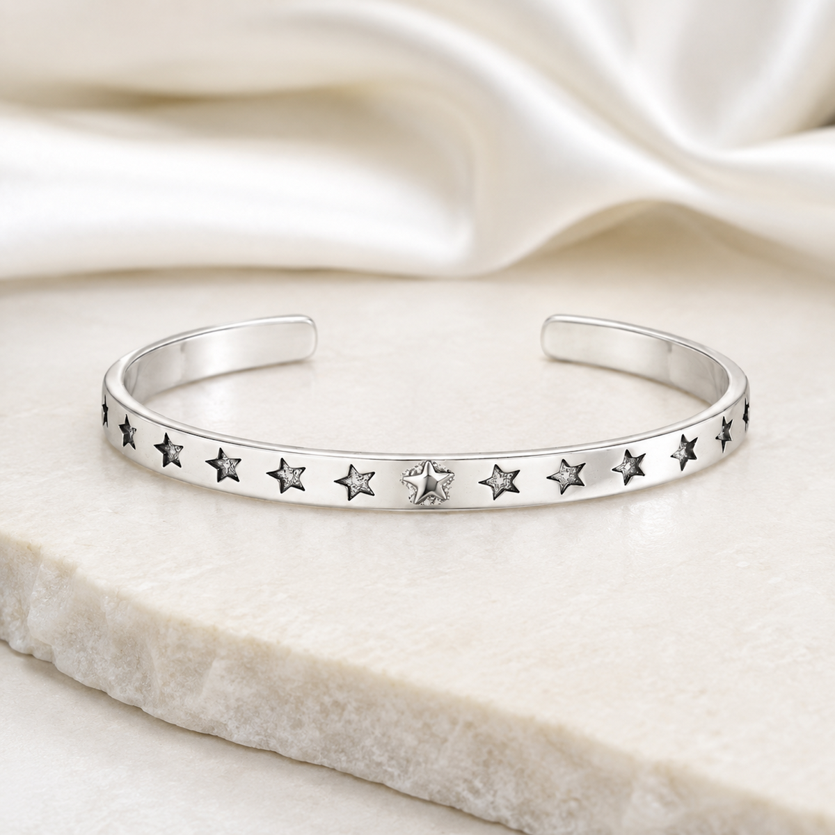 Silver Star Cuff Bracelet displayed on light marble