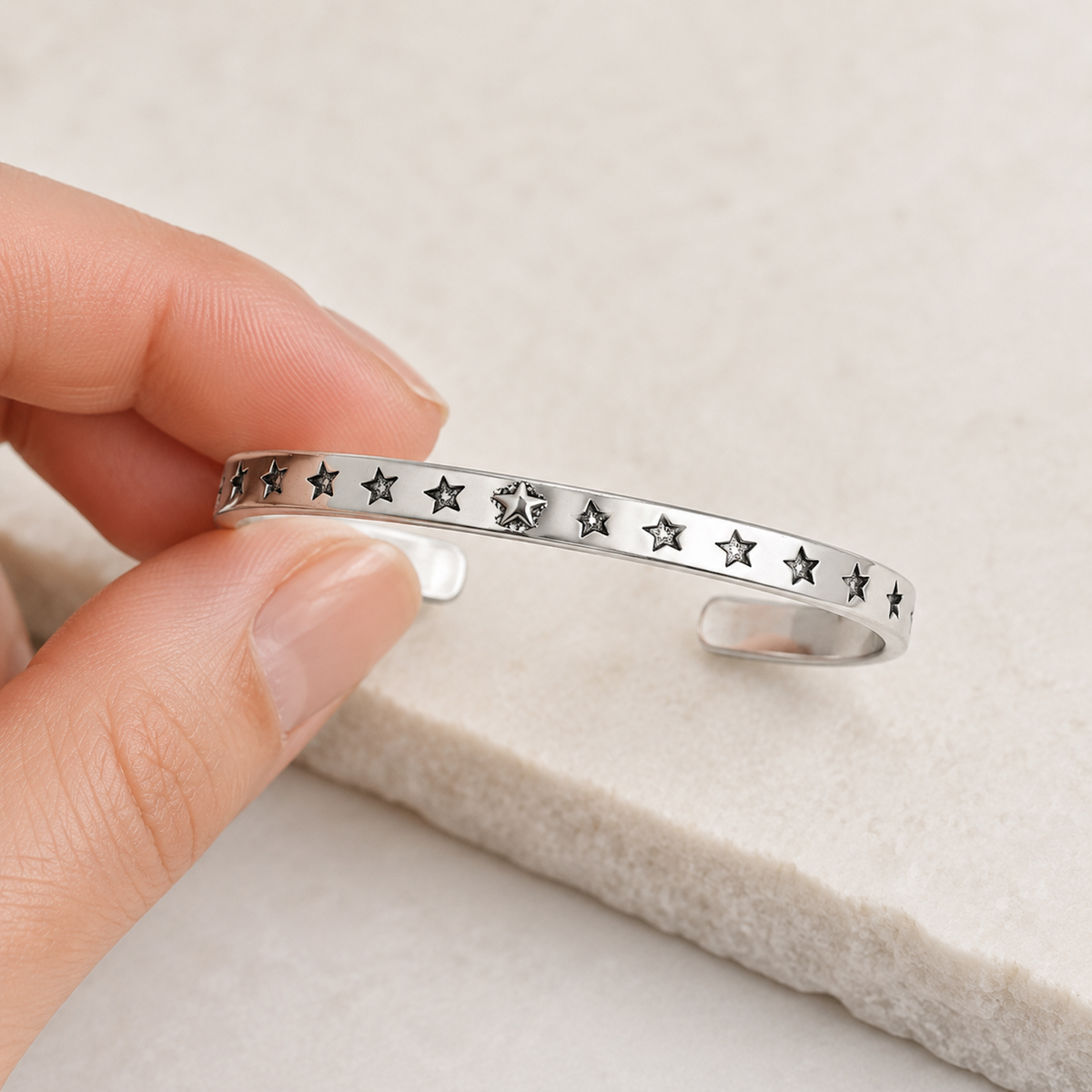 Silver Star Cuff Bracelet held in hand for scale