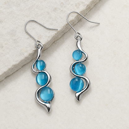 Blue Wave Dangle Earrings with three aqua-blue stones and silver wave-shaped frames