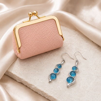 Blue Wave Earrings styled beside pink mini leather coin purse