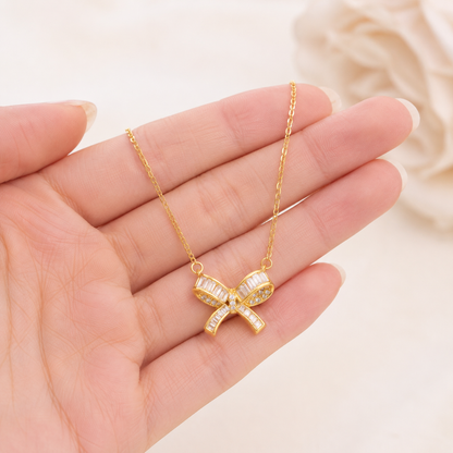 Gold Bow Pendant Necklace for Women shown with scale reference