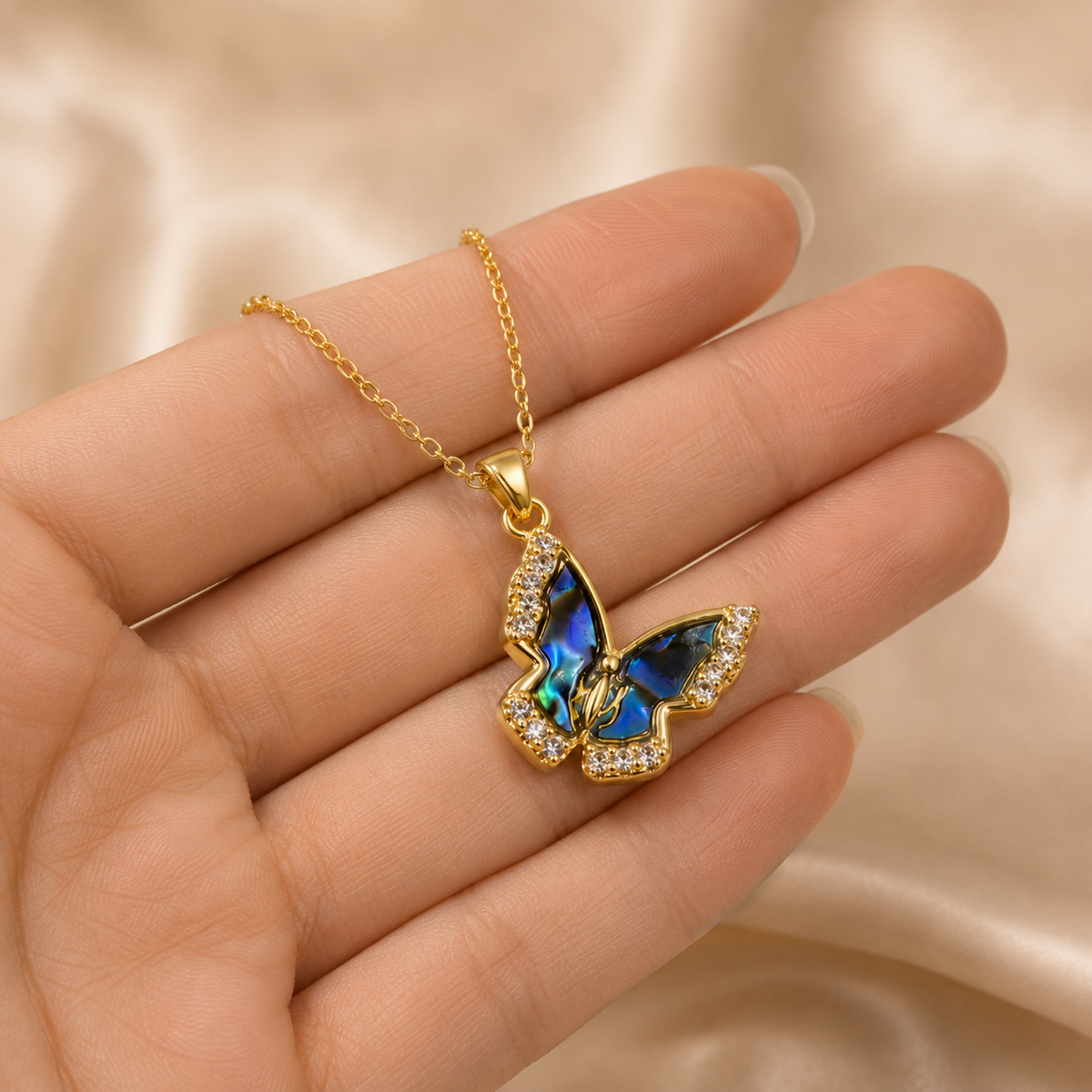 Natural Shell Butterfly Pendant Necklace shown in hand for scale