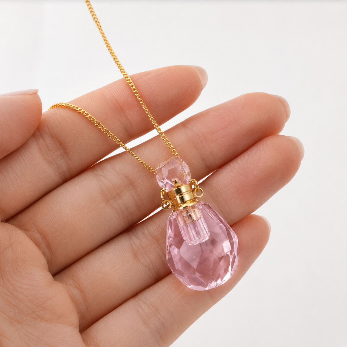 Pink Crystal Perfume Bottle Necklace shown with scale reference